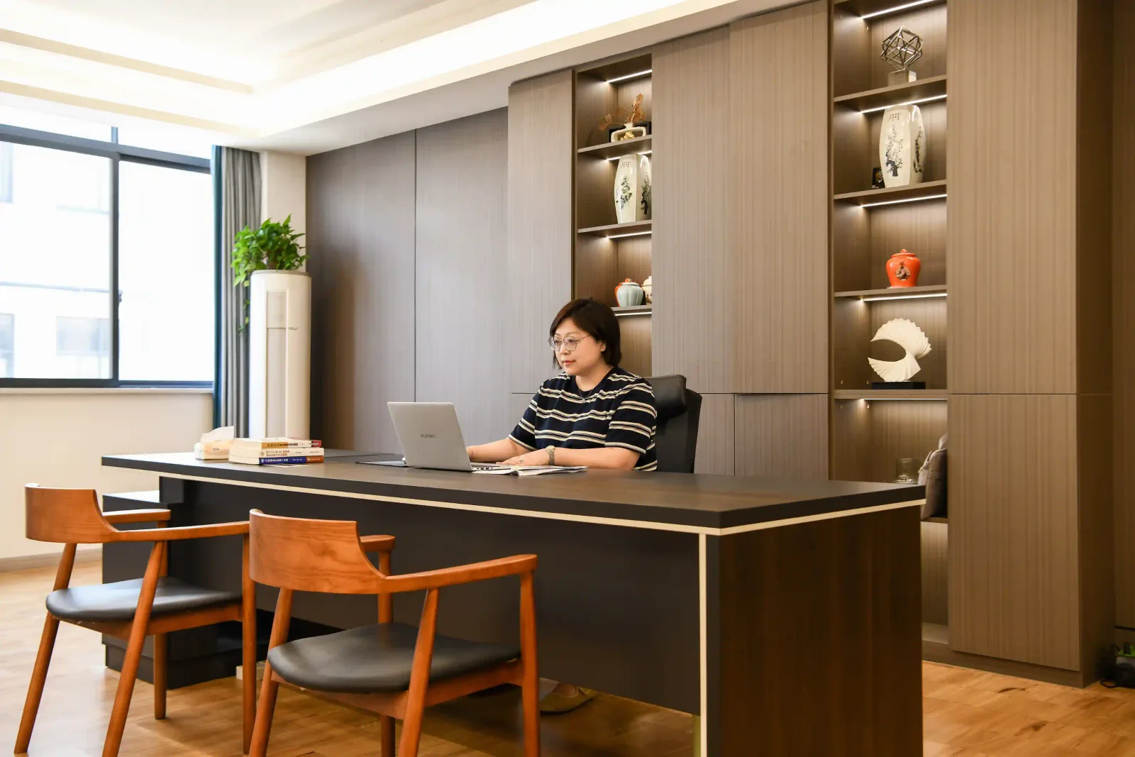 HAO Eyewear founder at the company's Shenzhen head office desk