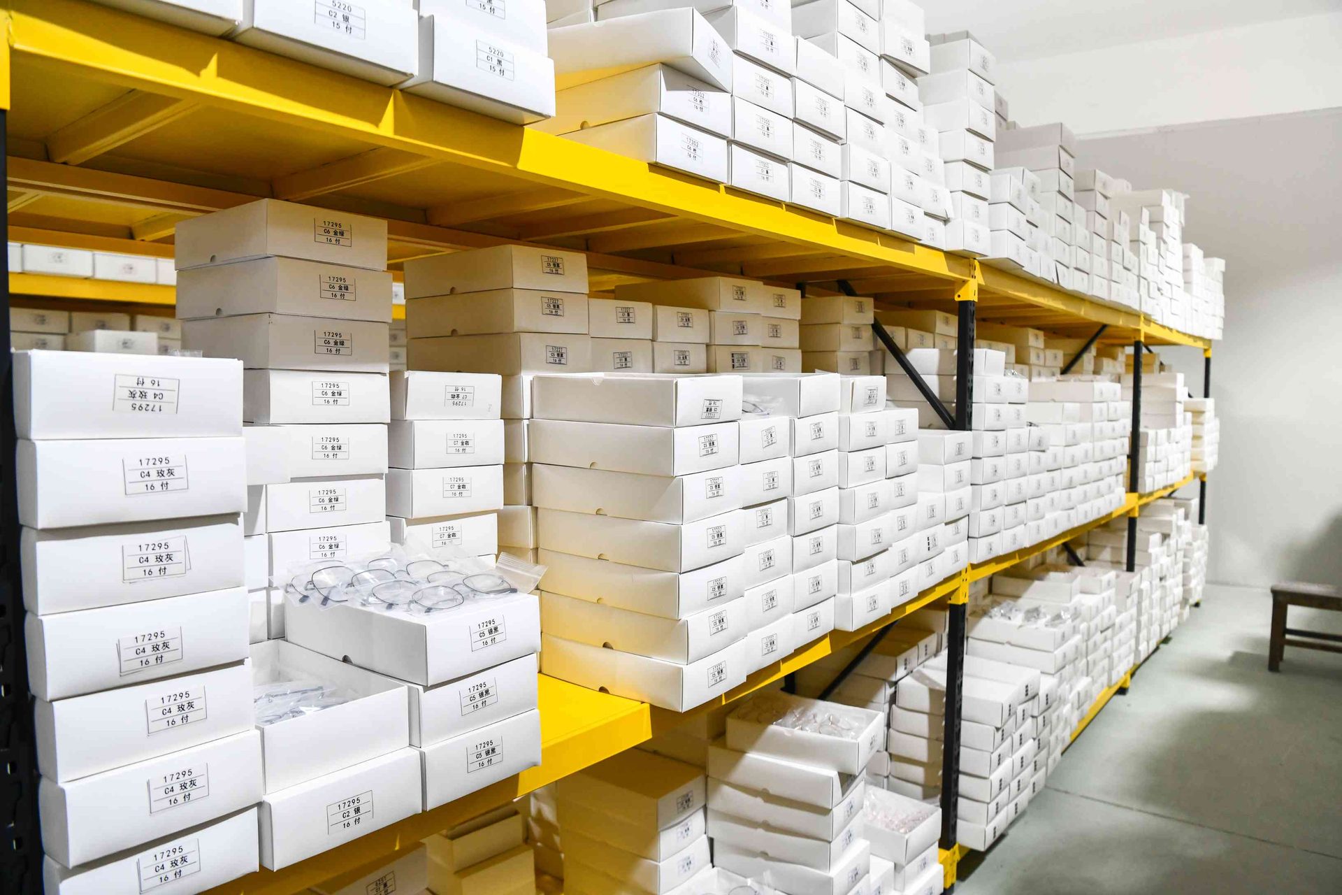 Detailed view of SKU-labeled eyewear boxes in HAO Eyewear ready stock warehouse