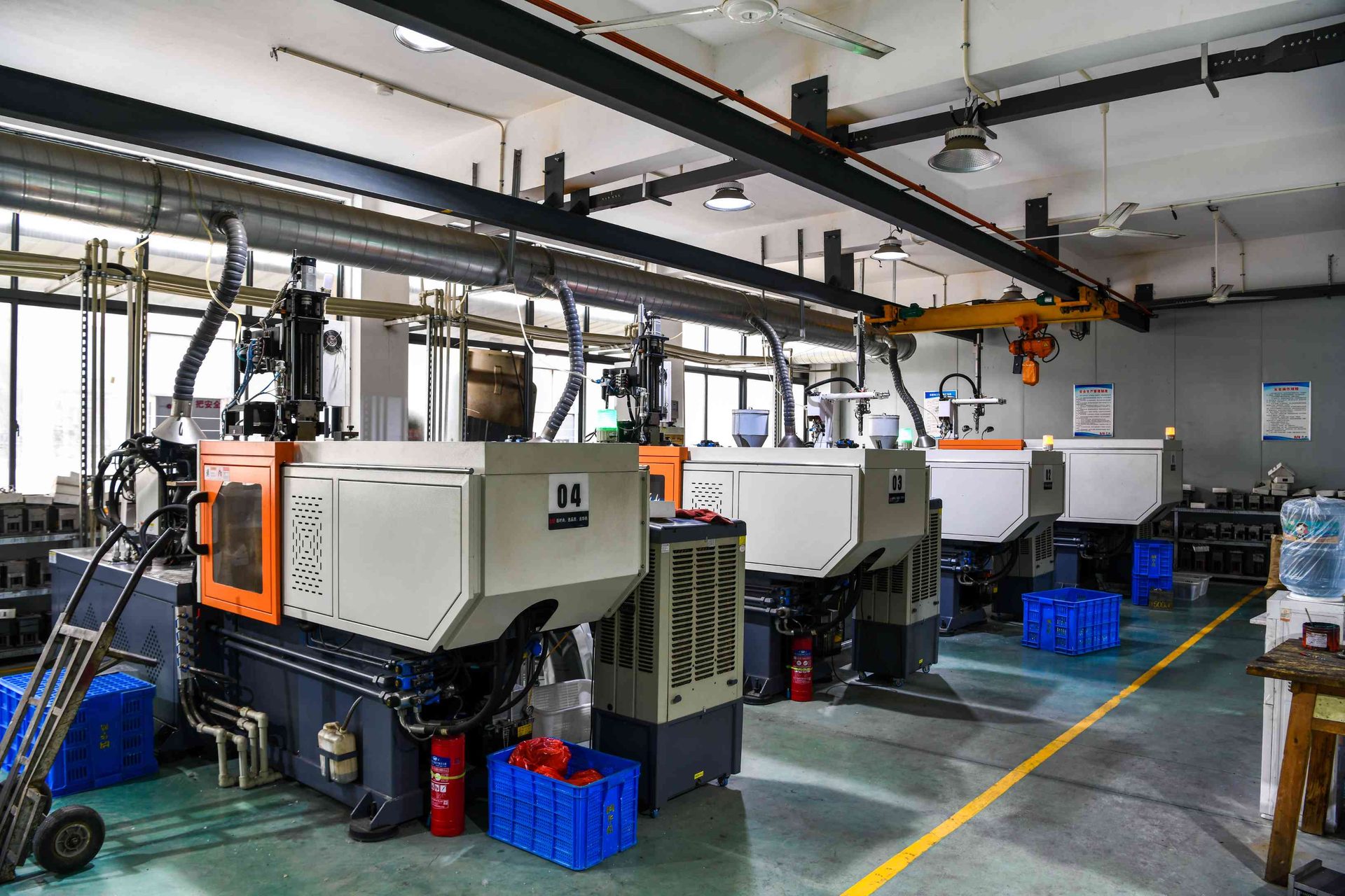 Multiple TR90 injection molding machines numbered 04 and 03 in operation at HAO Eyewear
